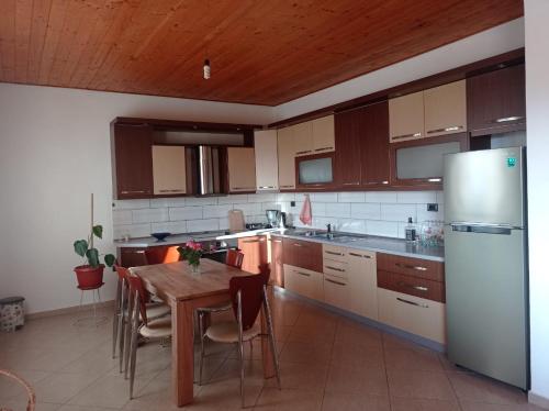 a kitchen with a table and a refrigerator at Private House Durres in Durrës