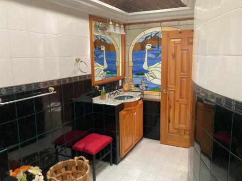 a bathroom with a sink and a mirror at Bungalow And Surf in Cabo San Lucas