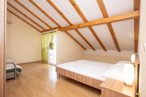 a bedroom with a large white bed in a room at Apartments with parking space Pirovac, Sibenik - 22567 in Pirovac