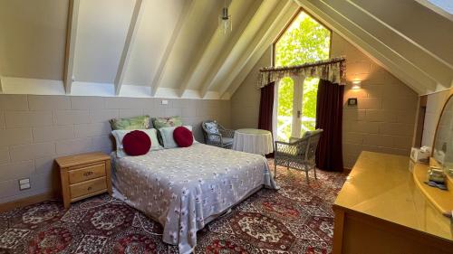 a bedroom with a bed and a large window at Father House in Kaiapoi