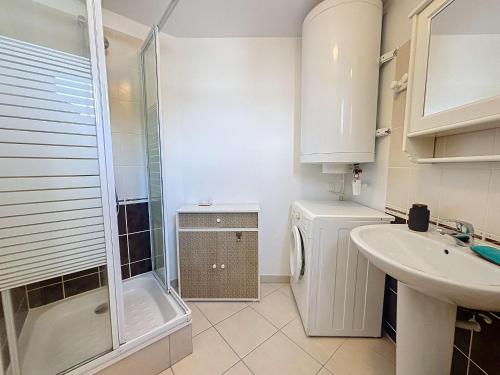 y baño con ducha, lavabo y lavadora. en Appartement Donville-les-Bains, 2 pièces, 2 personnes - FR-1-361-442, en Donville-les-Bains