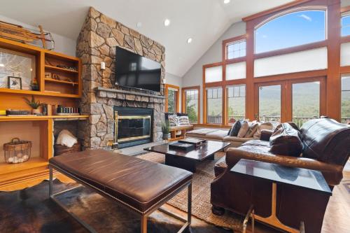 a living room with a couch and a fireplace at Stunning Mountain Views Game Room Sleeps 16 in Lincoln