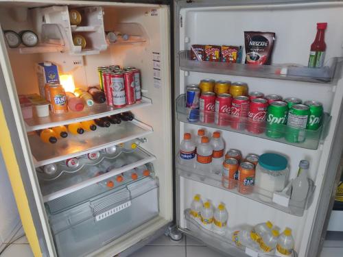 an open refrigerator filled with lots of food and drinks at Casa perto do Centro de Convenções in Recife