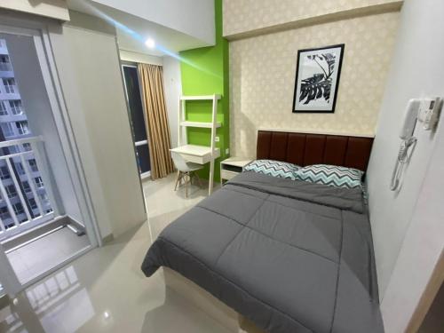 Ένα ή περισσότερα κρεβάτια σε δωμάτιο στο Agrippina Rooms T a m a n Melati Apartement near Malioboro