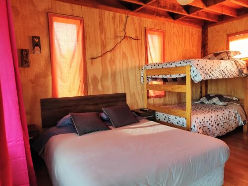 a bedroom with two bunk beds in a cabin at Rustico Pucon in Pucón