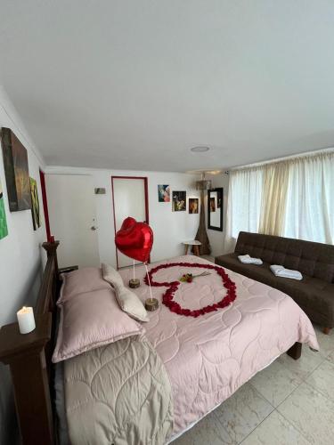 a bedroom with a large bed and a red chair at Villa Ocampo in Salento