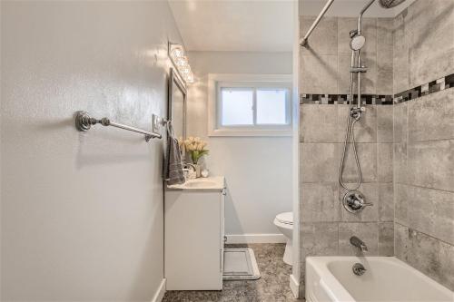 a bathroom with a shower and a toilet and a sink at Colorful Colorado Home - 20 min to Denver in Northglenn