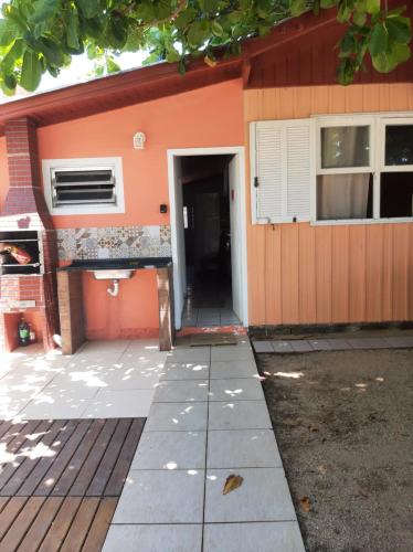 a building with a door leading to a building at Pé na areia, casa na praia de frente para o mar in Florianópolis