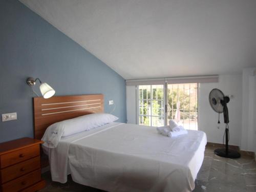 a bedroom with a bed and a window and a fan at Villa Murcia, 5 dormitorios, 10 personas - ES-220-34 in Alcantarilla