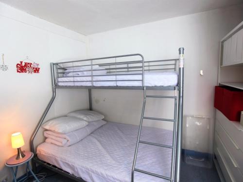 a bunk bed in a room with a ladder at Studio Avoriaz, 1 pièce, 3 personnes - FR-1-314-280 in Morzine