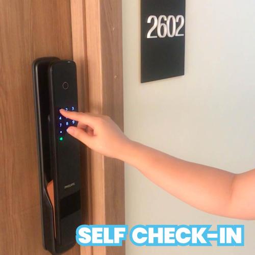 a persons hand is pressing a button on a door at 2 Bedroom Condo @ Midpoint Residences w/ City View in Mandaue City