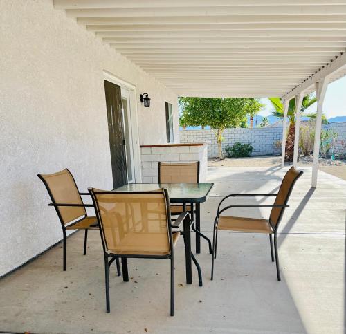 a patio with a table and chairs on a porch at Casa Feliz Arizona in Fort Mohave