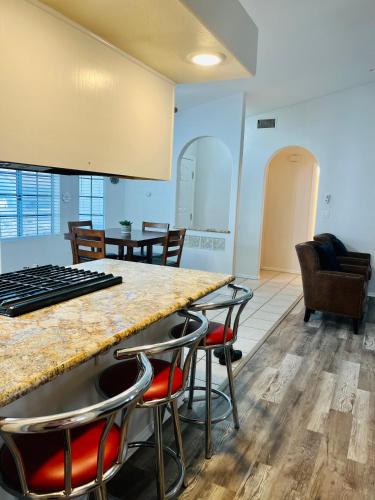 a living room with a counter and chairs at Casa Feliz Arizona in Fort Mohave