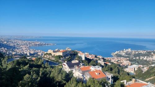 an aerial view of a city and the ocean at Arcadia Guesthouses - Ghazir, Lebanon in Ed Dkârîne