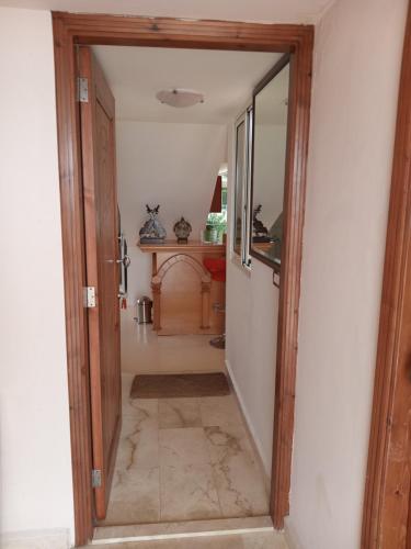 a hallway with a door leading into a room at Arcadia Guesthouses - Ghazir, Lebanon in Ed Dkârîne