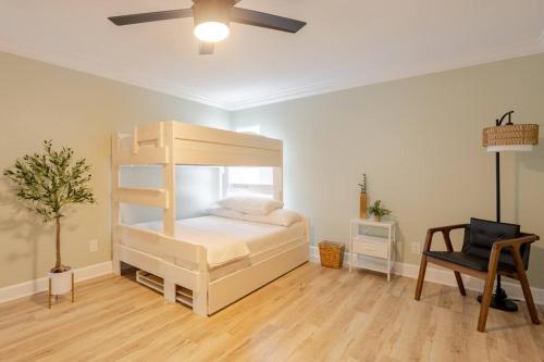 a bedroom with a bunk bed and a chair at Oceanview Retreat/Perfect for Groups/Heated Pool in Fort Myers Beach