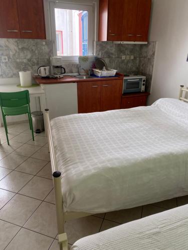 a bedroom with a bed and a kitchen at Igoumenitsa heart flats to let Mariasroom studios appart seaside-city Spyropoulos in Igoumenitsa