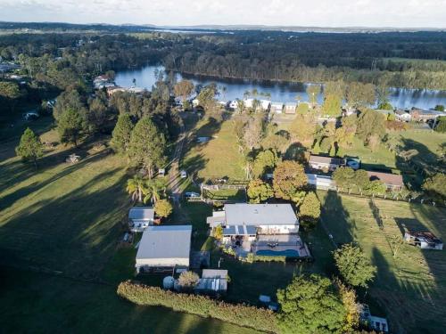 an aerial view of a house with a river at Dora Creek Cottage in Dora Creek