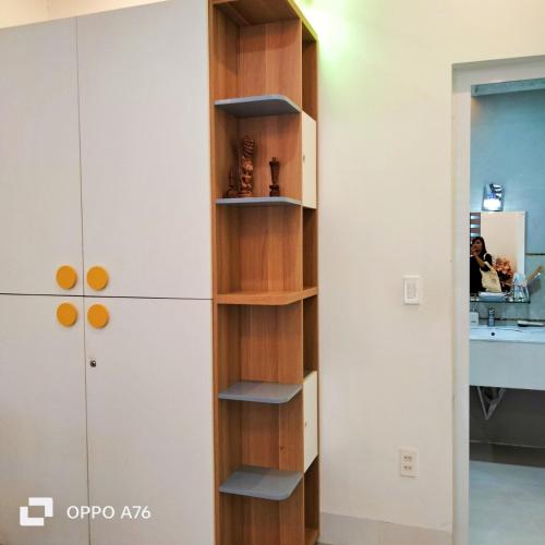 a book shelf in a kitchen next to a refrigerator at Happiest Homestay 1 - Manor Crown Hue in Hue
