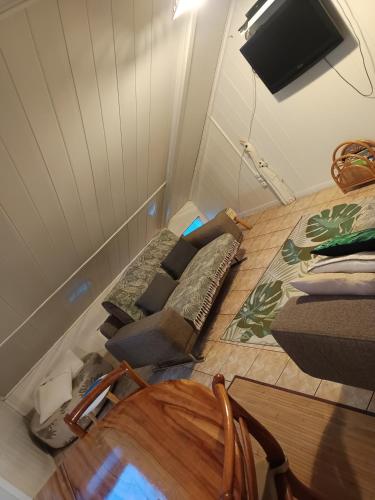 a small room with a bed and a couch at Cascades de la mare à poule d'eau in Salazie
