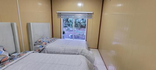 Postel nebo postele na pokoji v ubytování Cabañas el Farolito