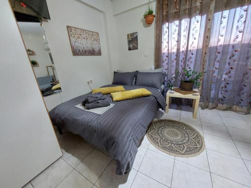 a bedroom with a large bed in a room at Anthexia's Studio Volos in Volos