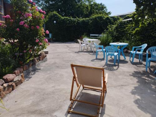 a bunch of chairs and tables and chairs and flowers at Guest house on Akmatbai-Ata 29 in Cholpon-Ata