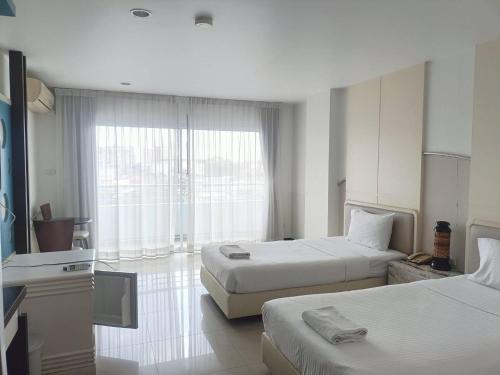 Ένα ή περισσότερα κρεβάτια σε δωμάτιο στο The Great Hotel Hatyai
