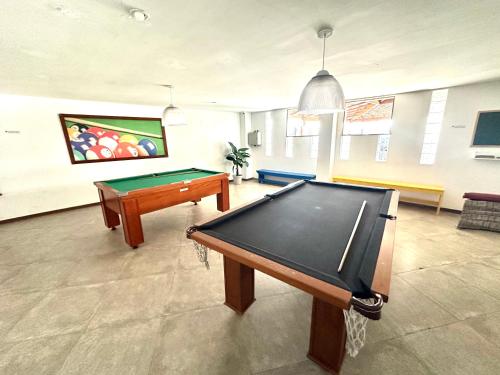 a billiard room with a pool table and ahibition at Apartamento até 8 Pessoas Praia Grande - Le Bon Vivant in Arraial do Cabo