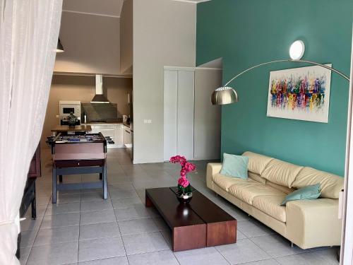 a living room with a couch and a table at chez Gérald in Noumea