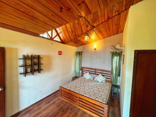 a bedroom with a bed and a wooden ceiling at Mysa by Meraki - Entire Villa with Himalayan Views in Rānīkhet