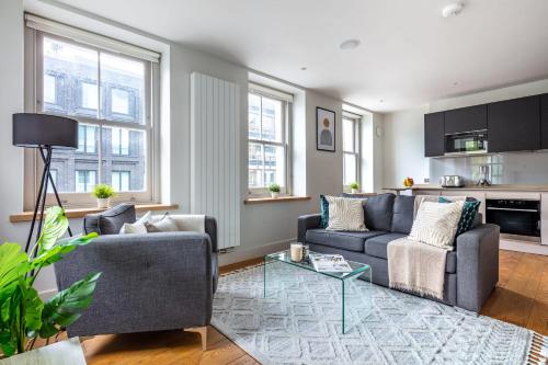 a living room with two couches and a table at Central Fitzrovia - CityApartmentStay in London