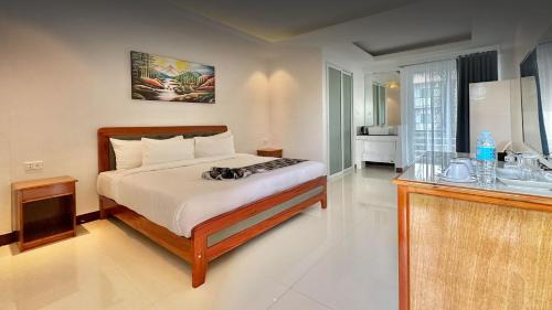 a bedroom with a bed and a sink in it at The XIMO Suites in Boracay