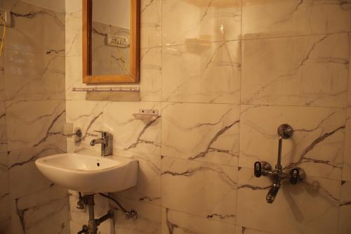a bathroom with a sink and a mirror at Karma Lodge - "A Boutique stay in Leh" in Leh