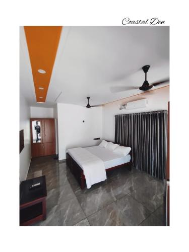 a bedroom with a bed and a tv in it at Coastal Den Homestay in Pallipuram
