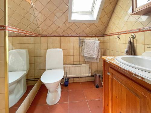 a bathroom with a toilet and a sink at Holiday home ASKIM III in Askim