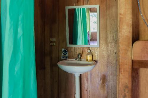 a bathroom with a sink and a mirror at Kichwa Lodge in Aguarico