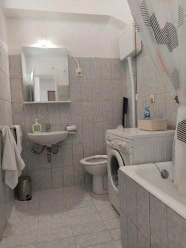 a bathroom with a washing machine and a sink at Apartment Nadja in Split