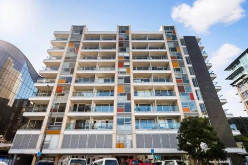 a tall building with cars parked in front of it at Loft Apartment in Wellington
