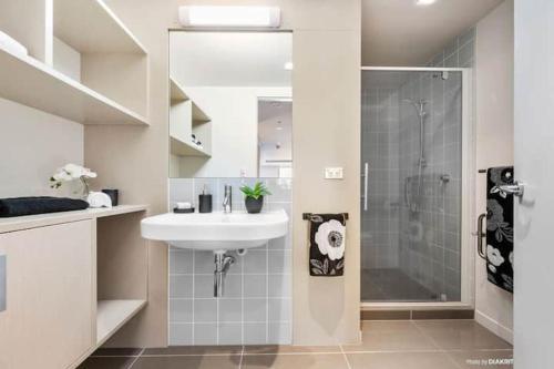 a white bathroom with a sink and a shower at Loft Apartment in Wellington