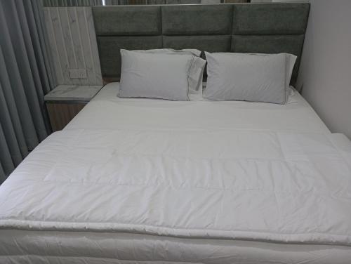 a large bed with white sheets and pillows at SleepRest - Nuvasa Bay in Nongsa