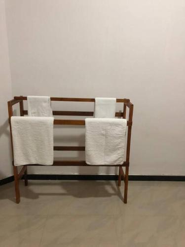 a wooden bench with two white towels on it at Vedagedara villa in Tangalle