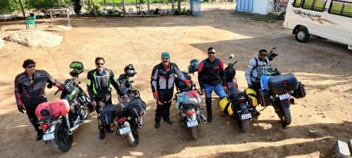 a group of men standing next to their motorcycles at Jungle Tree Hostel Hampi in Hampi