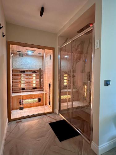a shower with a glass door in a bathroom at La Dependance Luxury Bed and Breakfast in Fondi