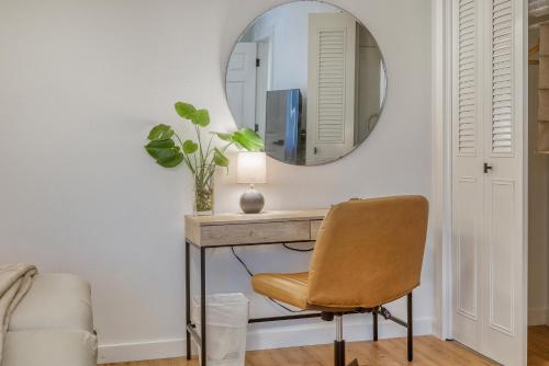 a mirror on a wall above a desk with a chair at Zen Haus Serene Retreat, prime location with views in Eugene