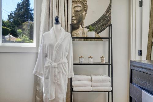 a robe on a rack next to a window at Zen Haus Serene Retreat, prime location with views in Eugene
