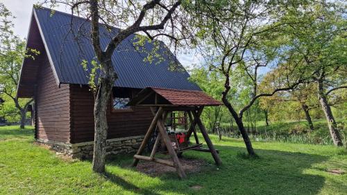 a house with a solar roof on top of it at Sătucul de Vacanță Brăduleț in Uleni