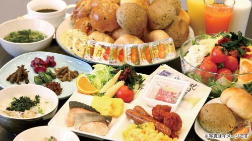 a table with many plates of food on it at Hotel Castle Plaza Tagajo in Tagajo