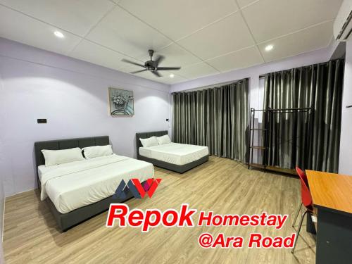 a hotel room with a bed and a table and a table at REPOK HOMESTAY in Sarikei