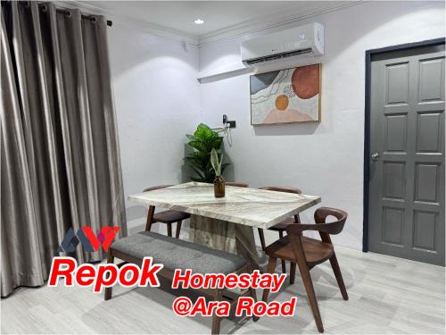 a room with a table and chairs and a door at REPOK HOMESTAY in Sarikei